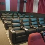 A row of seats in an empty theater.