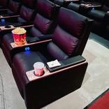 A row of seats in an empty theater.